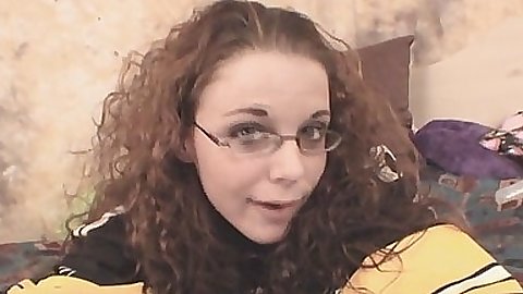 Cute girlfriend in glasses plays with a tv remote