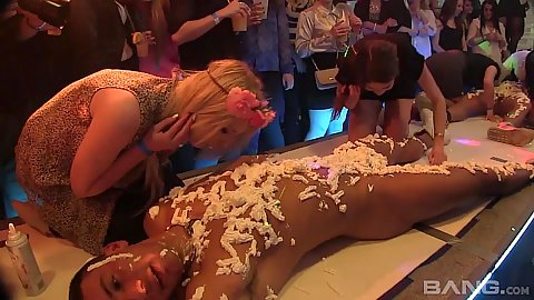 Eating some food off male stripper body at club