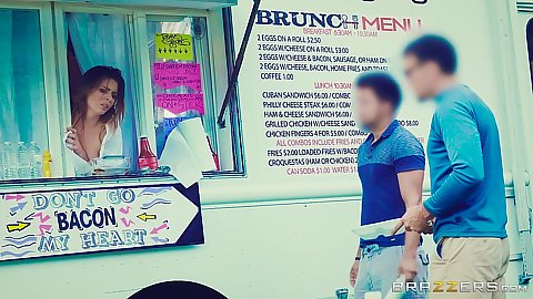 Alex Blake looking out of the window of a food truck while getting fingered