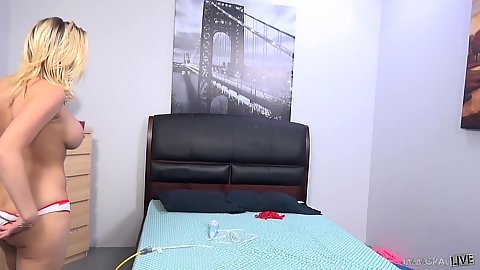 Big jugged blonde solo Kagney Linn Karter goes on bed to masturbate and show off pussy piercing