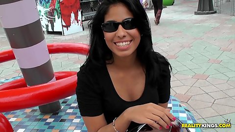 Sexy latina in a short white dress outdoors