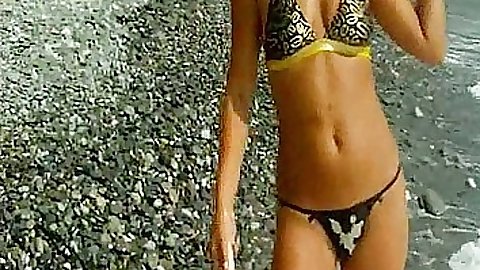 Beach babe on the rocks filmed