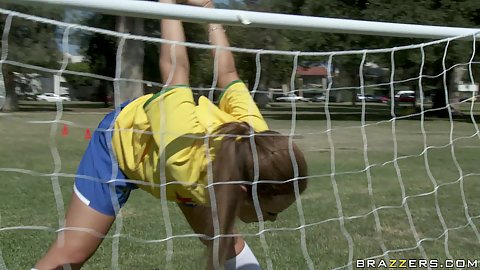 Sexy chick playing some soccer outdoors