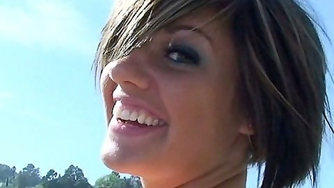 Solo outdoors Haily James poses in her mini skirt